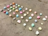 Dual Ice Storm.2.1, 2022, installation 15 glass jars filled with melted snowballs colored and melted during a performance, variable dimensions, unique pieces. Performance in Chicago, Illinois, USA, 2025